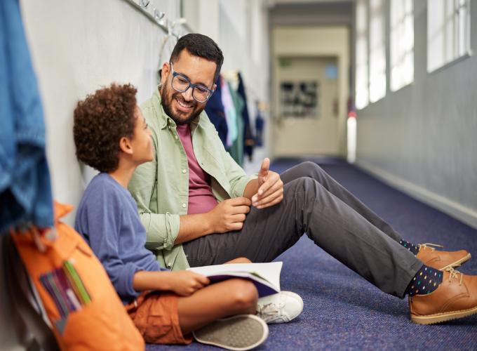 Male mentor and kid in school